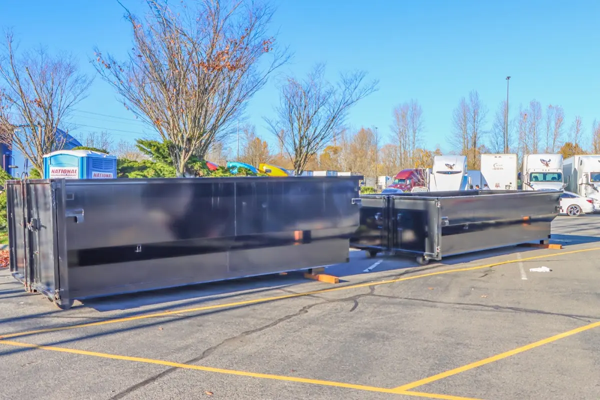 Professional dumpster rental service with roll-off container on residential driveway in Williamsville